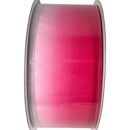 Spool of pink ribbon on a white background