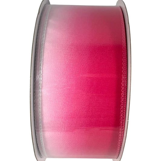 Spool of pink ribbon on a white background