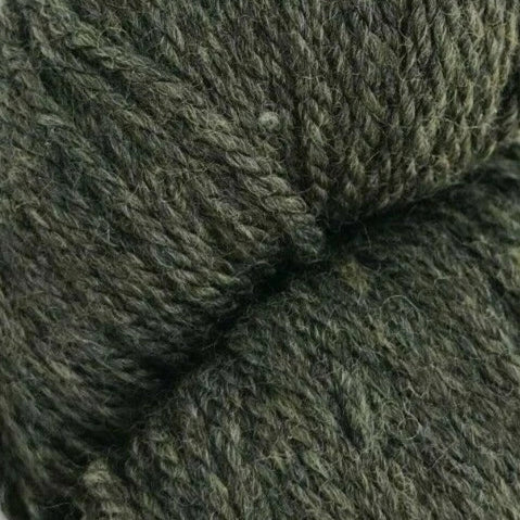 Close-up of a skein of dark green yarn on a white background