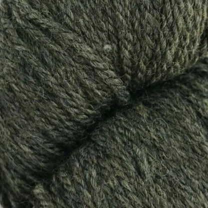 Close-up of a skein of dark green yarn on a white background