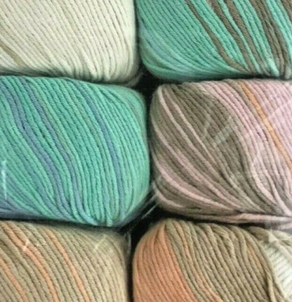 Close-up of various skeins of yarn in pastel colors.