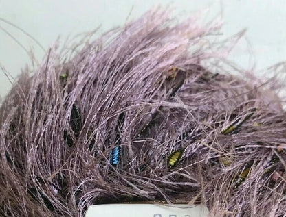 Close-up of purple synthetic hair with a label in the foreground