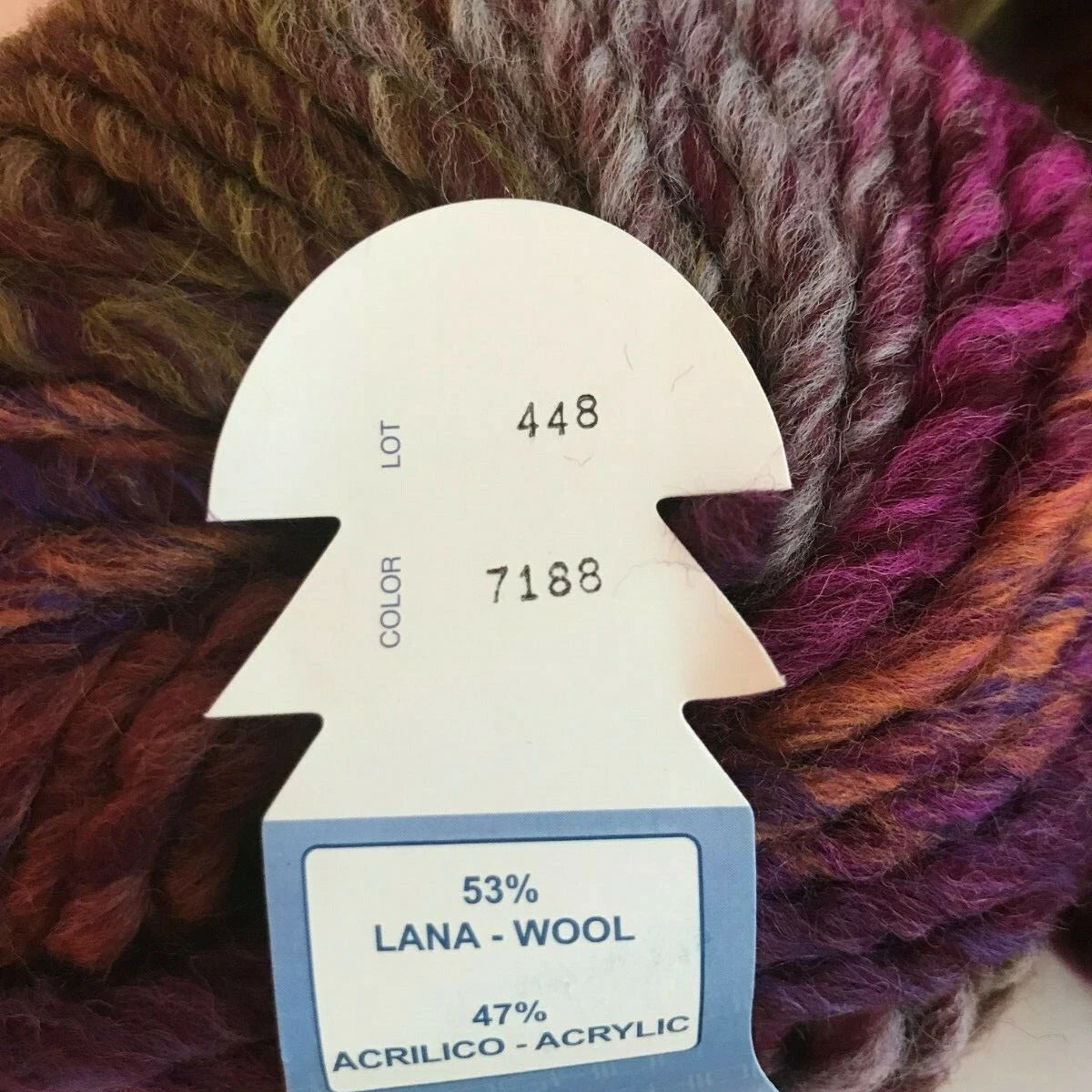Yarn ball with a label indicating yarn composition and details
