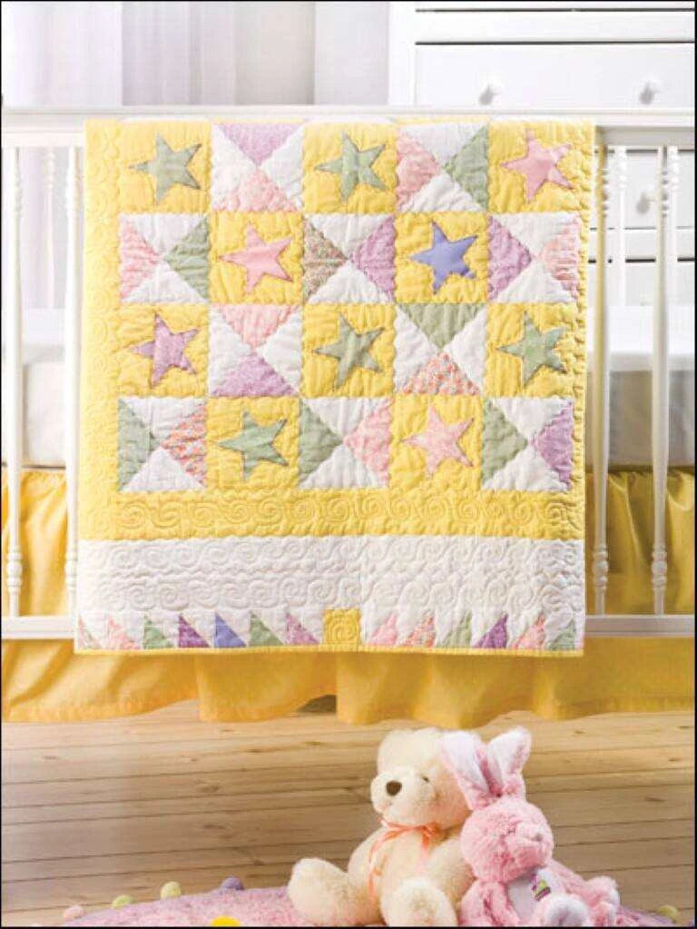 Quilt with star pattern in a nursery setting with teddy bears and crib.