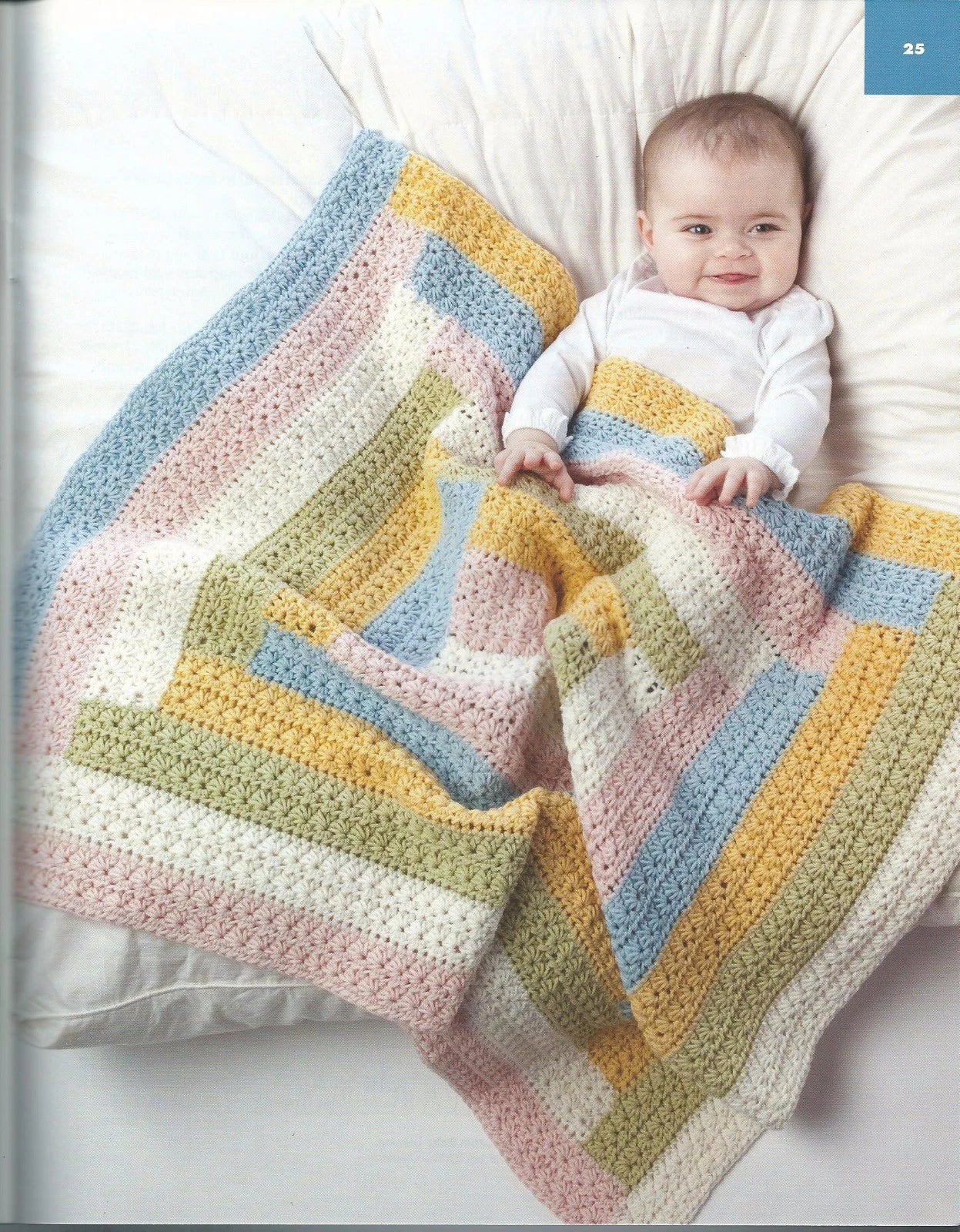 Baby lying on a colorful striped blanket