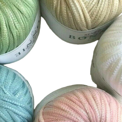 Five balls of yarn in pastel colors with visible brand labels.