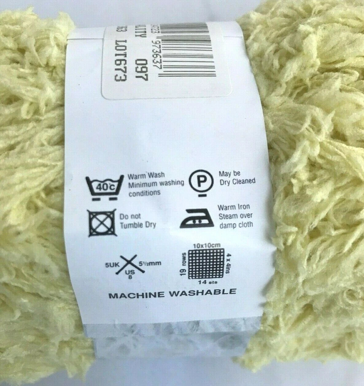 Yarn ball with a label showing washing instructions on a white background