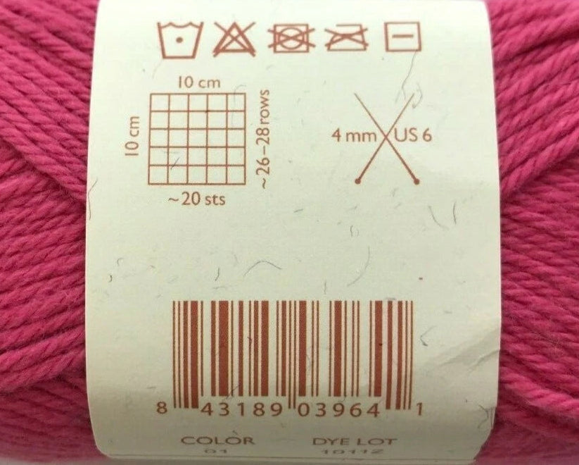 Close-up of a label on a ball of pink yarn with measurement and care instructions.