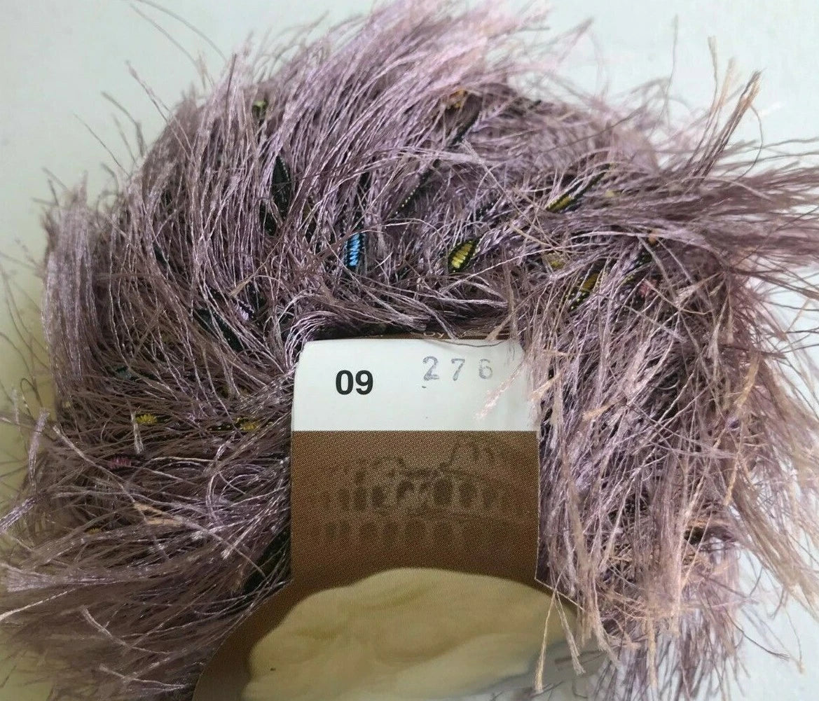 Ball of purple yarn with a label on a light background
