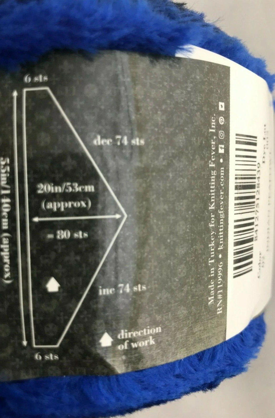 Blue yarn with a label showing knitting instructions and measurements.