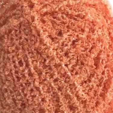 Close-up of a textured pinkish-orange fabric surface