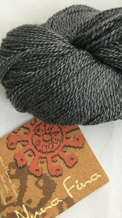 Gray skein of yarn with a label on a white background