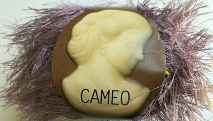 Cameo stone with 'CAMEO' text on a bed of straw