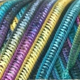 Close-up of colorful zippers in various colors including purple, yellow, and blue.