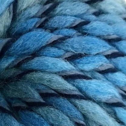 Blue skein of yarn with a label on a white background