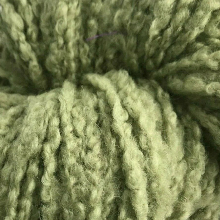 Green skein of yarn on a white background
