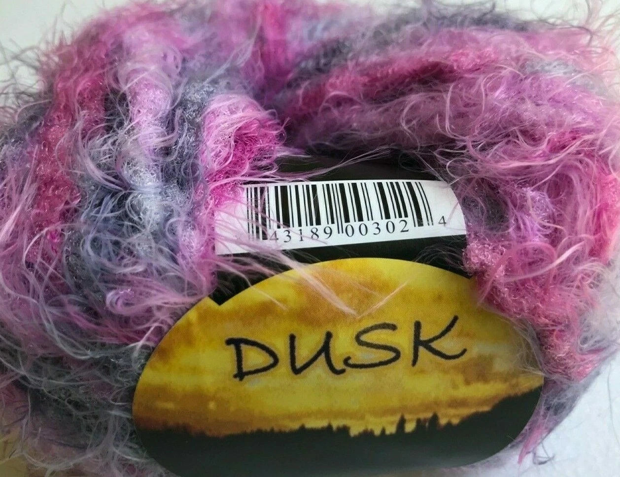 Multicolored yarn skein with a 'DUSK' label on a white background