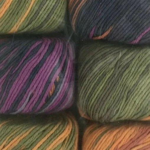 Close-up of colorful yarn balls arranged in a square pattern.