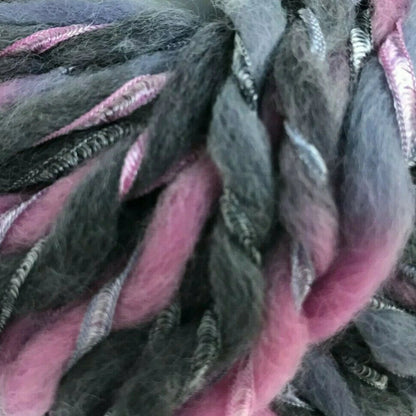 Ball of gray and pink yarn on a white background