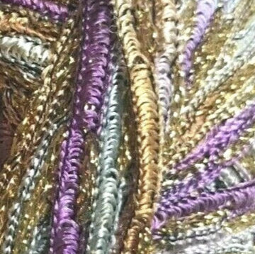 Close-up of metallic thread in gold, purple, and silver.