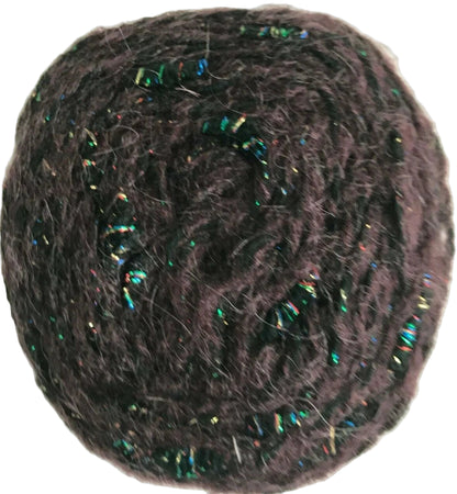 Ball of dark yarn with metallic fibers on a white background