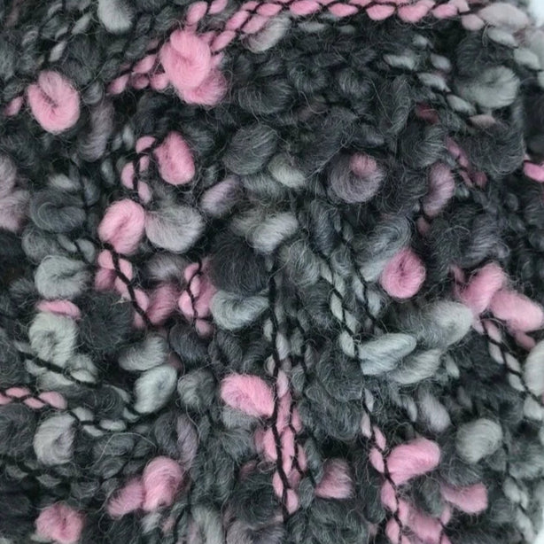Close-up of knitted fabric with pink and green yarn