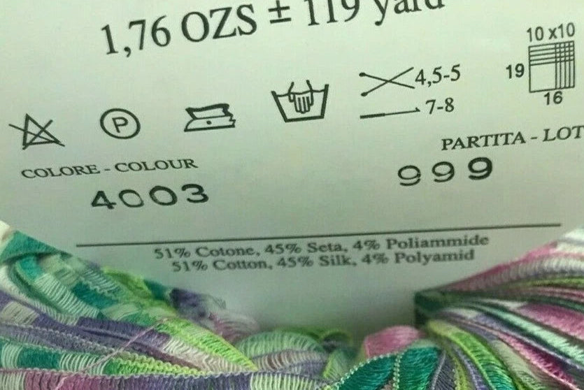 Yarn ball with label showing color code, weight, and material composition.
