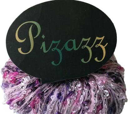 Decorative yarn ball with 'Pizazz' label on a white background