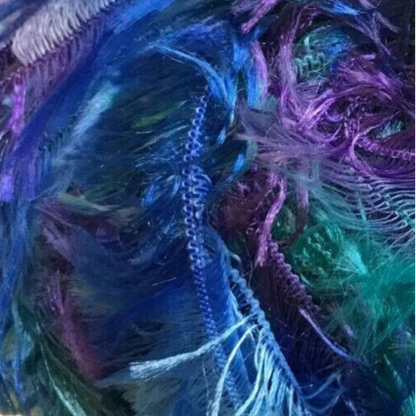 Close-up of colorful yarn with blue, purple, and green hues.