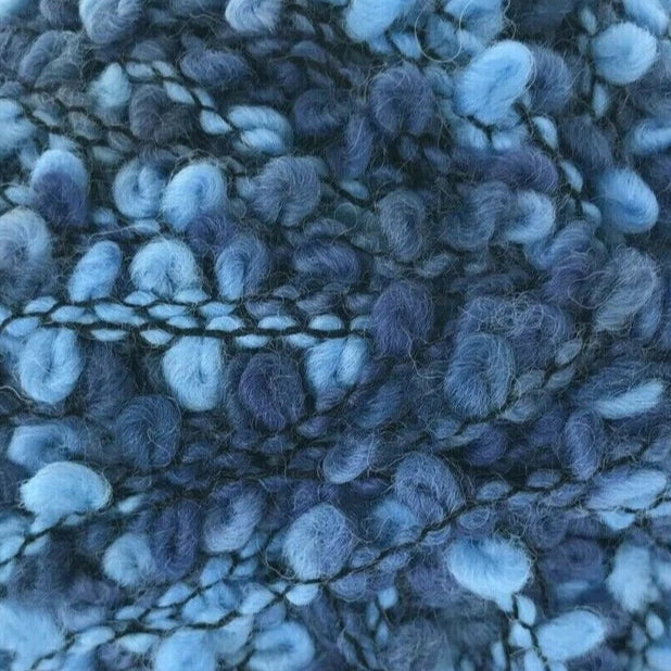 Blue textured yarn ball on a white background