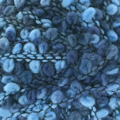 Blue textured yarn ball on a white background