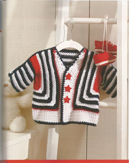 Children's striped sweater with red stars on a hanger against a wooden background