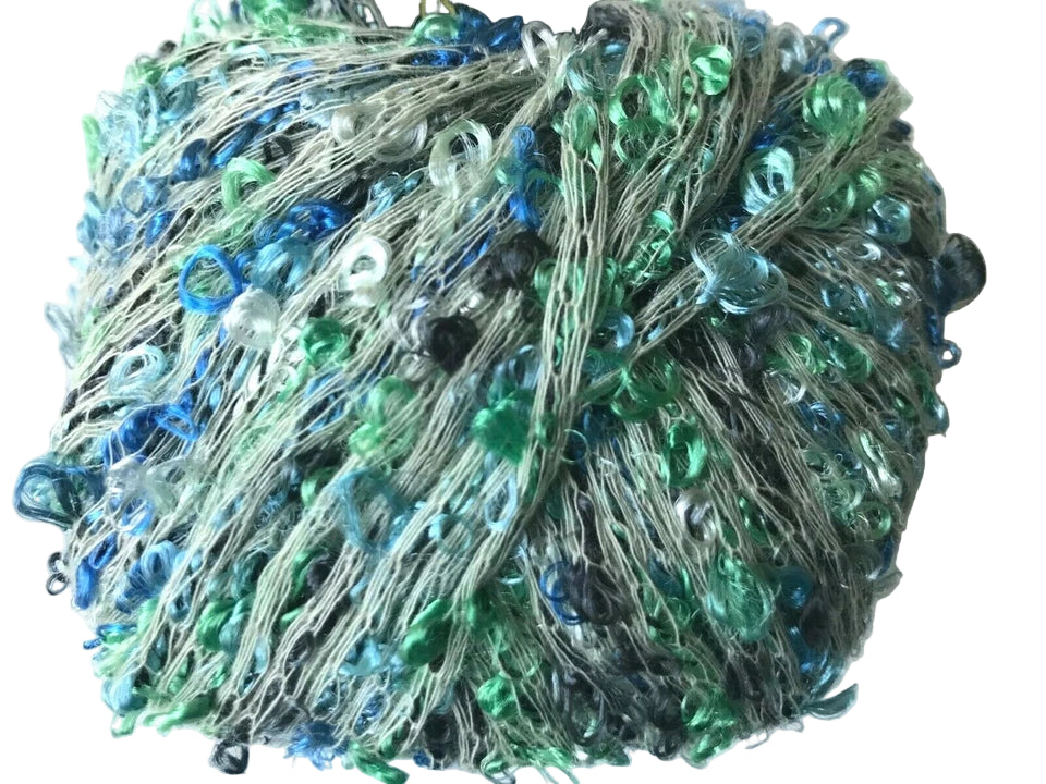 Collection of blue and green glass beads on a white background