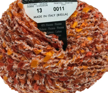 Spool of multicolored yarn with a label indicating 'Made in Italy (Biella)'.