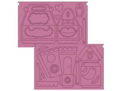 Pink rubber stamp set with various shapes and designs on a white background
